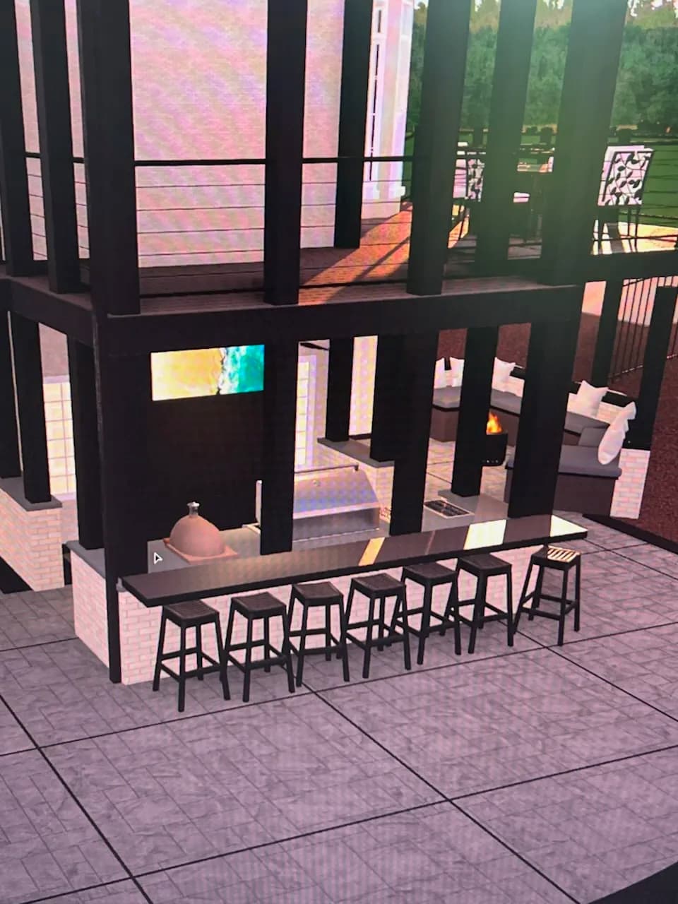 Modern outdoor kitchen with bar seating, sleek design, and fireplace in a stylish patio setting.