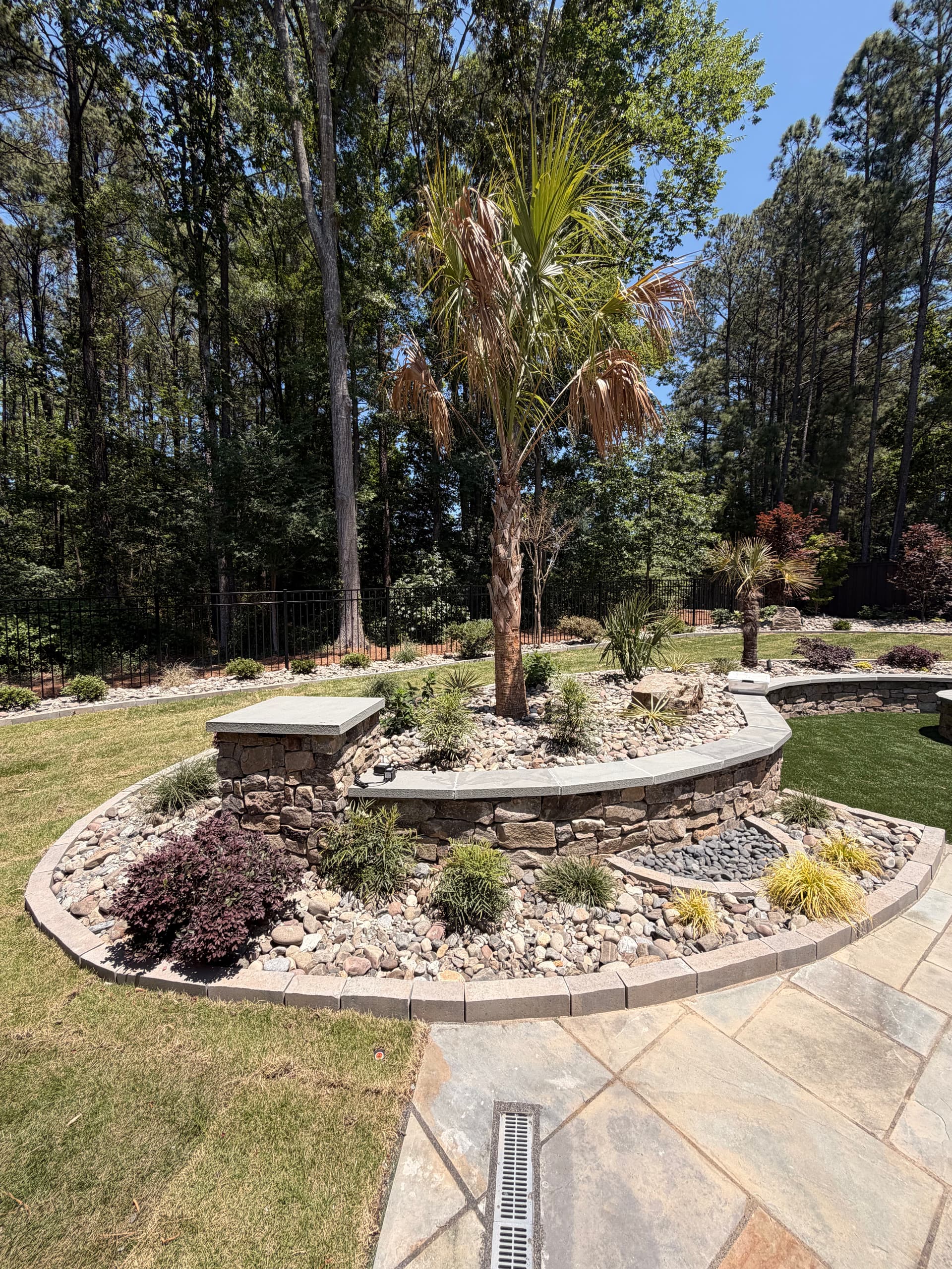 Custom Backyard Design with Fire Pit Retaining Walls and Garden Features image